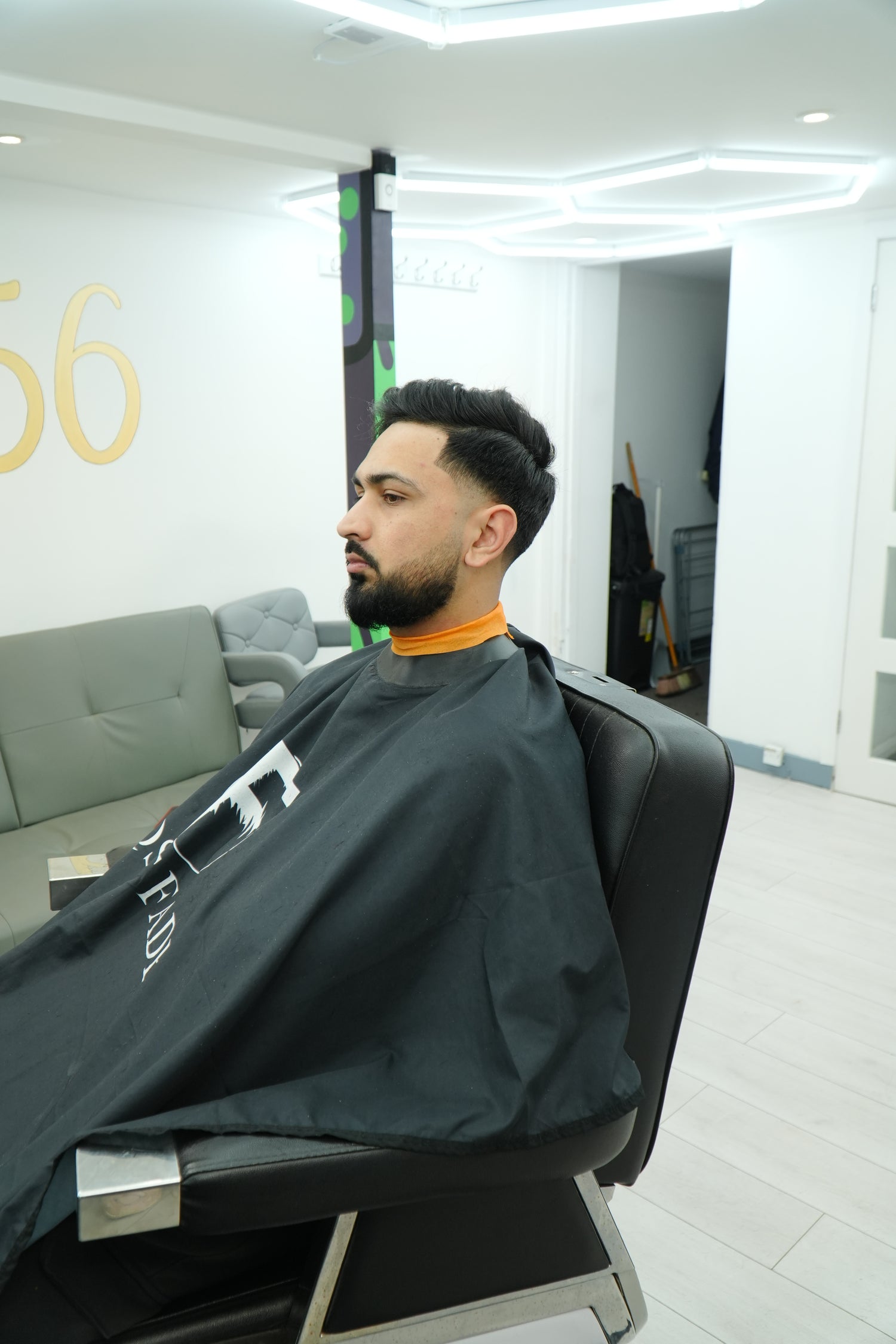 Person wearing a dark jacket with visible branding in an indoor setting